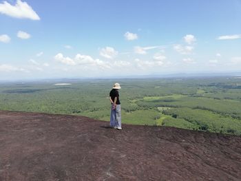 Full length of woman looking at landscape against sky