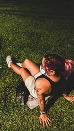 Full length of woman lying on grassy field