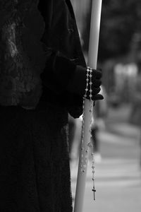 Rear view of person holding cross