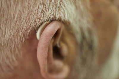 Close-up of senior man with hearing aid