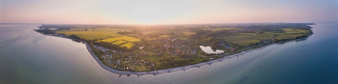 Aerial view of city against sky during sunset