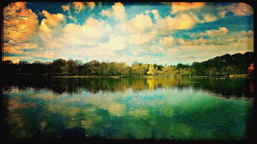 Scenic view of lake against cloudy sky