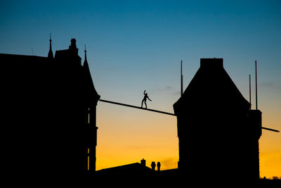 Low angle view of silhouette building against sky during sunset