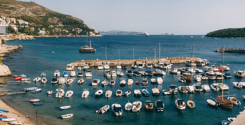 High angle view of sailboats moored on sea against sky