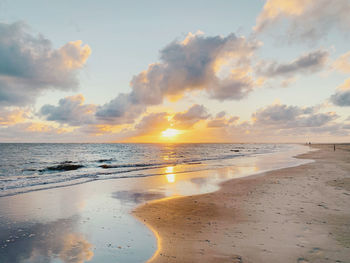 Scenic view of beach against sky during sunset