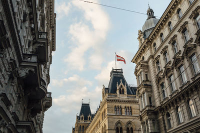 Low angle view of buildings against cloudy sky