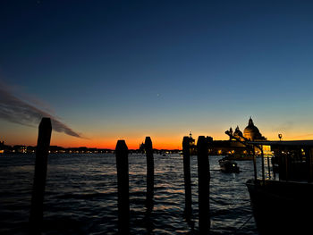 Scenic view of canal grande venice against sky during sunset