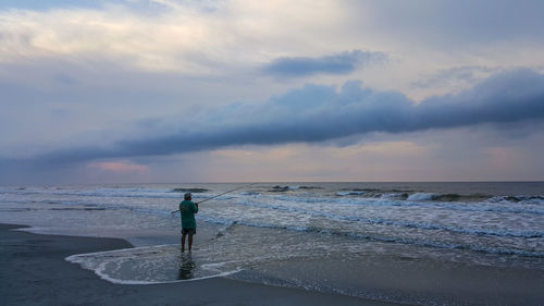 Man on beach against sky