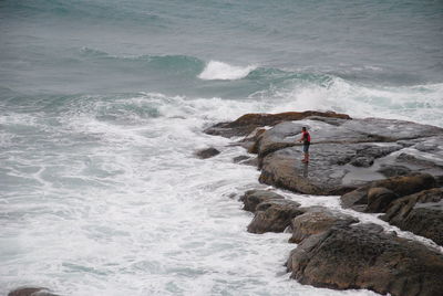 High angle view of man fishing in sea