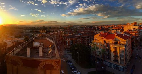 Cityscape against sky at sunset