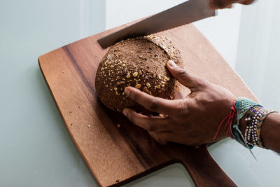 Close-up of person preparing food on cutting board
