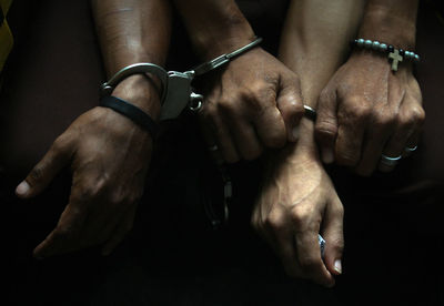 Cropped hands with handcuffs