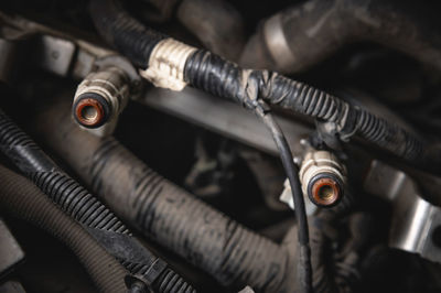 Old dirty injectors on the fuel rail in selective focus