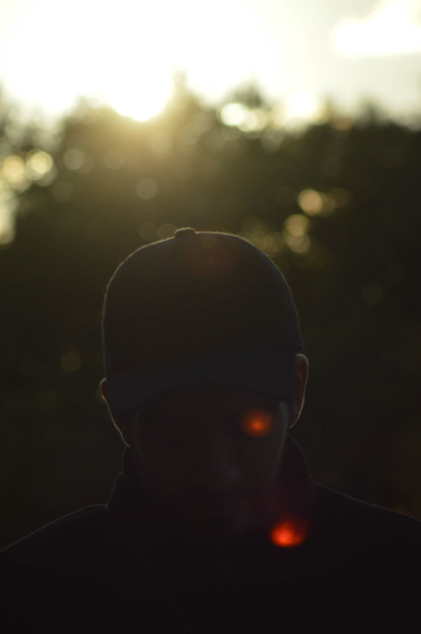 CLOSE-UP OF MAN IN ILLUMINATED LIGHT