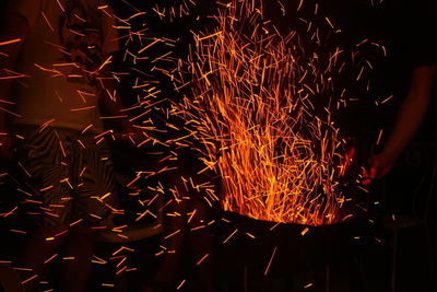 Low angle view of firework display at night