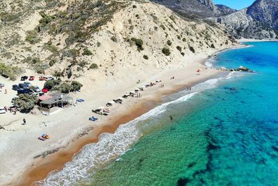 Aerial view of mountain by turquoise sea