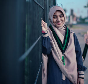Portrait of smiling young woman standing outdoors