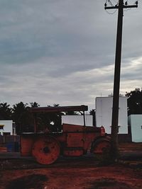 Abandoned tractor on field against sky