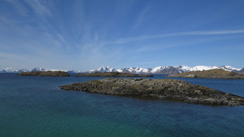 Scenic view of sea and mountains against sky