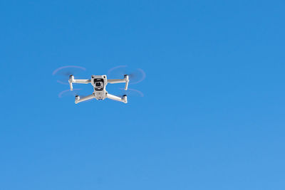 Drone front view in flight on clear sky
