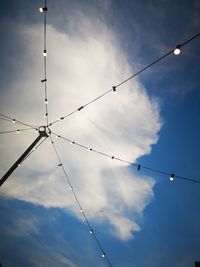 Low angle view of electricity pylon against sky