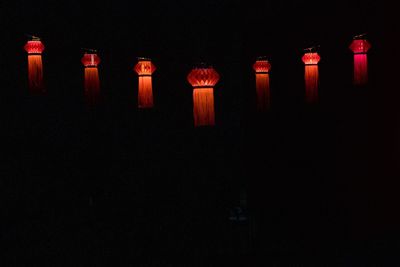 Illuminated lanterns in dark room