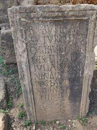 Close-up of text on stone at cemetery