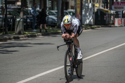 Man riding bicycle on road