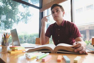 Young man studying in library