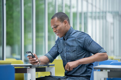 Side view of man working on table