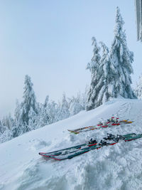 People skiing on snow covered mountain against sky