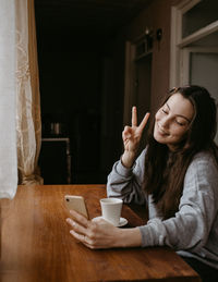 Young woman sitting on table