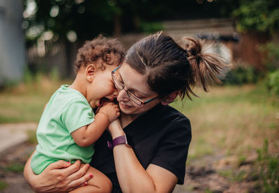 Mother and daughter smiling outdoors