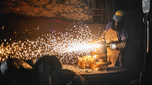 Man wielding machine at factory