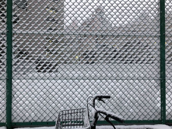 Man seen through chainlink fence