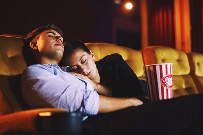 Couple relaxing with popcorn in movie theater