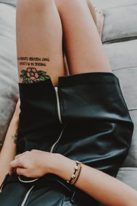 Low section of woman with tattoo on her thigh