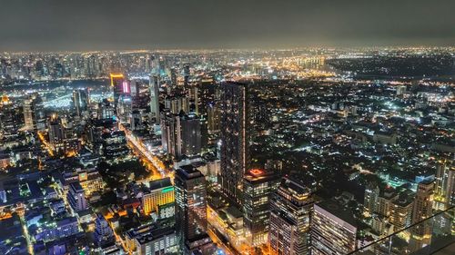 High angle view of city lit up at night