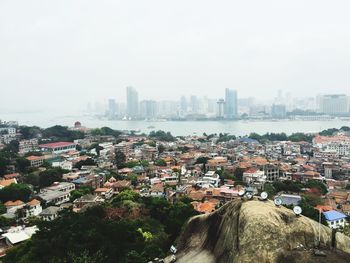 High angle view of buildings in city against sky