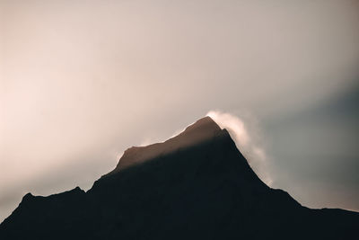 Low angle view of silhouette mountain against sky at sunset