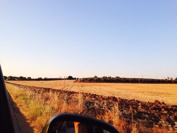 View of agricultural field against clear blue sky