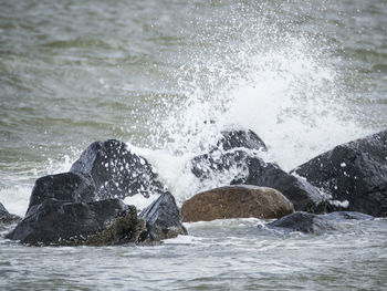 Sea waves splashing on rocks