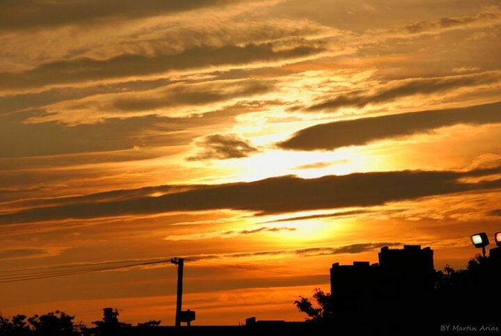 sunset, silhouette, orange color, sky, architecture, built structure, building exterior, cloud - sky, low angle view, beauty in nature, scenics, dramatic sky, city, nature, cloud, outdoors, no people, idyllic, moody sky, building