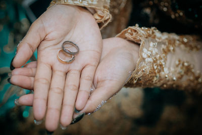Close-up of couple holding rings