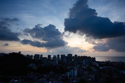 Silhouette buildings against sky during sunset