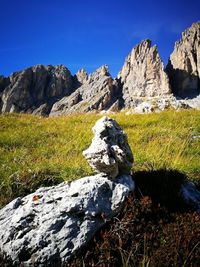 Rock formations on landscape against blue sky