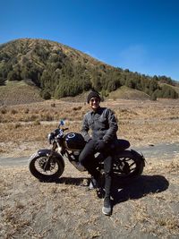 Man riding motorcycle on field