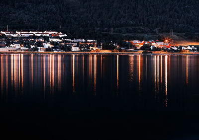 Scenic view of lake against sky at night