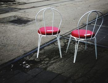 High angle view of red chairs on sidewalk