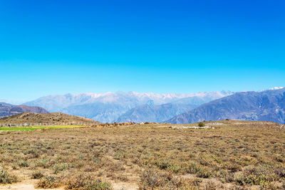 Scenic view of mountains against blue sky